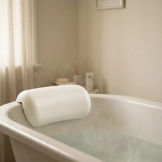The Restore Bath Pillow mounted on white bath edge warm bathroom — Kosient